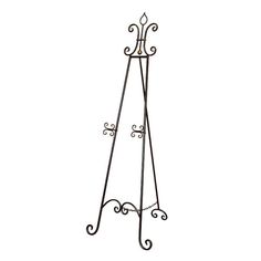 a metal coat stand with two hooks on it's sides and an ornate design