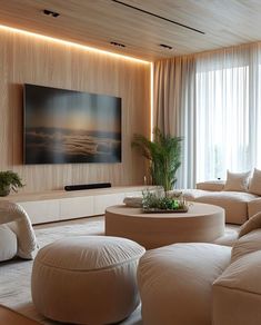 a living room filled with furniture and a flat screen tv mounted to the side of a wall