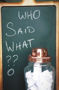 a chalkboard with the words who said what? written on it next to a jar filled with crumpled paper