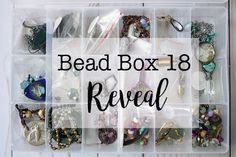 a box filled with lots of different types of beads and jewelry on top of a wooden table