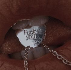 a close up of a person's mouth with a chain around it and the word flud you on it