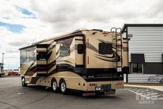 an rv parked in a parking lot next to a building