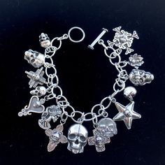 "Vintage looking sterling silver skull charms of various designs combine to make this perfect bracelet for the skull lover. Approx. 7.5 inches of handmade chain with simple hook and eye closure so you can vary length. You will not be getting the bracelet in the photo. Each is one-of-a-kind and has 15 Skull charms. All the charms are my unique designs and made of solid Sterling silver. Made when you order so please allow up to three weeks. Award-winning craftsmanship in 100% sterling silver handm Silver Metal Bracelet With Custom Hardware, Silver Skull Bracelets In Punk Style, Punk Silver Skull Bracelets, Edgy Silver Jewelry With Charms, Silver Bracelet With Custom Hardware, Silver Gothic Skull Bracelets, Edgy Silver Skull-shaped Jewelry, Edgy Silver Skull Jewelry, Punk Style Nickel Free Silver Bracelet