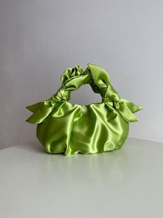 Handmade small lime bag is crafted from smooth satin. Woman stylish satin bag is soft, but keeps its shape, closes with a magnetic button. Furoshiki knot bag is made in vintage style, based on the Japanese technigue of tying a silk scarf in a bag. Small evening handbag is able to decorate not only official event, but also becomes a companion for every day. The handbag consists of 3 layers: the outer material and the lining are satin, with a special seal between them so that the handbag keeps its shape. Small evening handbag can also be sewn from soft pleasant velvet. There are three versions of satin evening bag: -mini Height 15cm Width 25cm Handle drop 20cm -small Height 20cm Width 30cm Handle drop 25cm -big Height 25cm Width 40cm Handle drop 30cm Color in the photo - LIME Material: Soft, Tying A Silk Scarf, Knot Bag, Woman Handbag, Wedding Bag, Handmade Bag, Green Satin, Satin, Wedding Bags