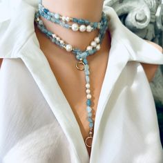 Introducing a stunning masterpiece of jewelry, the Hand Knotted Baroque Aquamarine & Fresh Water Pearls Necklace. This exquisite necklace features a mesmerizing combination of natural shaded aquamarine beads and lustrous freshwater pearls, meticulously hand-knotted to create a breathtakingly beautiful design. With a remarkable length of 65 inches, this unique necklace offers endless layering possibilities, allowing you to effortlessly elevate your style and create stunning statement looks. The g Blue Lariat Necklace With Natural Stones, Blue Gemstone Lariat Necklace, Blue Lariat Jewelry For Party, Blue Distinctive Necklaces For Party, Blue Necklace With Unique Variations For Party, Blue Necklaces With Unique Variations For Parties, Elegant Adjustable Blue Pearl Necklace, Elegant Blue Double Strand Necklace, Elegant Long Blue Beaded Necklace