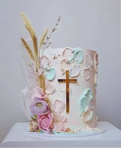 a cake decorated with flowers and a cross