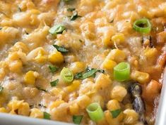 a casserole dish with corn and green onions