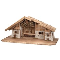 a wooden model of a small house with hay on the roof and windows in it