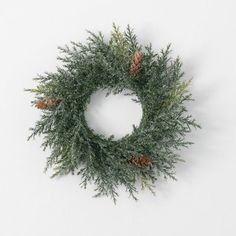 a pine cone wreath on a white background