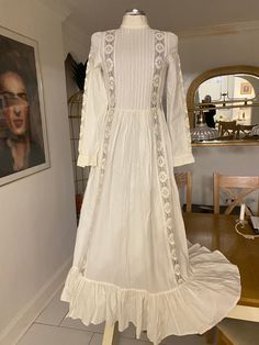 🕊Timeless beautiful white wedding dress by Laura Ashley 🕊Excellent condition with no flaws to note 🕊Pleated bodice and fits like a dream 🕊Measurements are vintage size 14 🕊18" pit to pit?>38"   🕊14" waist> 28"  🕊Hips free  🕊Cotton and beautiful lace trim details on the sleeves and bodice 🤍Button cuffs 🤍Concealed zipper at the back  🤍Long full flounce and flowing dress 🕊Look like an ethereal vampires wife in this showstopper of a timeless piece Vintage White Ball Gown Dress, White Vintage Ball Gown Dress, Fitted Wedding Dress With Lace Trim For Bride, Fitted Lace Trim Wedding Dress For Bride, White Wedding Dress With Lace Trim For Formal Occasion, Formal White Wedding Dress With Lace Trim, White Vintage Victorian Ball Gown, Regency Style White Victorian Dress For Debutante Ball, White Regency Victorian Dress For Debutante Ball