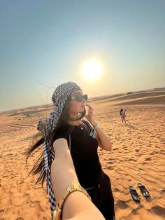 a woman is taking a selfie in the desert