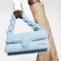 A Plush Iteration Of One Of Jacquemus' Classic Bag Silhouettes, The Le Bambidou Shoulder Bag In Blue Is Primed For The Colder Months. It's Made Entirely From Shearling And Accented With Gold-Tone Hardware. Internal Details: Fabric Lining, Card Slot Designer Color Name: Light Blue Made In Italy Comes With Dust Bag Closure: Magnetic Fastening Chain Shoulder Strap Back Pocket Jacquemus Bag, Fancy Bags, Classic Bags, Designer Shoulder Bags, Cute Bags, Metallic Logo, Lambskin Leather, Moda Operandi, Fashion Collection