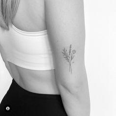 a woman's arm with a flower tattoo on the left side of her arm