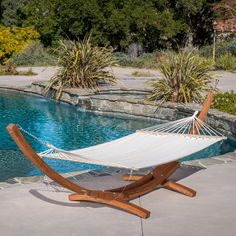 a hammock sitting next to a swimming pool