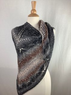 "This beautiful triangular shawl is made from Lion Brand's Shawl in a Ball yarn: 61% cotton, 34% acrylic, 5% metallic fiber. You can wear this lightweight shawl all year long. Color: brown, gray, beige, silver metallic  The metallic thread is much more visible in the reality then in the photos. Measurements are approximate : Length - 66\"168cm                                                             Height - 29\"/74cm   Weight- 5.3oz/ 150g                                                                                                                                   Care instructions: For the best results, hand wash recommended in cold water. Roll in to a towel and squeeze gently excess of water. Lay flat, reshape and dry. Didn't find what you were looking for? To see my other shawls c Shawl In A Ball, Knit Shawl, Metallic Knit, Lion Brand, Brown Silver, Knitted Shawls, Metallic Thread, Beige Brown, Shawls And Wraps