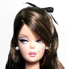 a close up of a doll with long hair