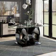 a modern dining table with glass top and metal base, in front of a large window