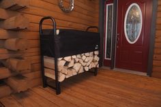 a bed made out of logs in front of a red door