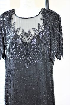 "Beautiful plus size Beaded and sequined black dress...perfect for that soiree that you have been wanting to go to for so long!! Excellent condition!! Measuring: 42\" length Bust: 46\"+ Waist: 42\" Hip: 50\" Pet Free/smoke free Enjoy!" Elegant Embellished Sequin Fabric For Evening, Elegant Embellished Evening Sequin Fabric, Holiday Black Sequin Fabric For Cocktail, Holiday Cocktail Black Sequin Fabric, Embellished Sequin Cocktail Dress With Short Sleeves, Black Sequin Dress With Contrast Detail For Wedding, Short Sleeve Embellished Sequin Cocktail Dress, Black Sequin Dress For Wedding With Contrast Sequins, Cocktail Sequin Embellished Short Sleeve Dress