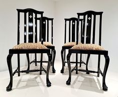 two black chairs with brown and white upholstered backrests in a room