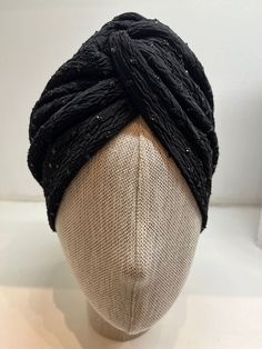 "This stylish black turban with bead embroidery has a rich texture outside & and has a soft and silky lining inside. It is a perfect headpiece for a smashing 1940s retro look. Gorgeous people with hair loss issues, this turban will make you feel amazing.  You can also style yourself with this sequin to honour your religious traditions. Simply place the turban on your head like a hat. Voila! It's effortlessly chic. This statement piece, sequin turban will turn heads towards you. So be ready for the compliments.  SIZE: One size (it fits most women) CARE: Handwash cold with a gentle soap & and air dry. COLOR: Shiny black (Different electronic devices may show the colours slightly different) GIFT RECOMMENDATION  This stylish sequin turban makes a great gift for your loved ones. We send it dire Elegant Black Headwrap Headband, Elegant Evening Turban Headband, Elegant Fitted Black Headwrap, Adjustable Black Traditional Turban, Traditional Adjustable Black Turban, Elegant Black Adjustable Turban, One Size Black Headwrap For Party, One Size Black Turban For Party, Elegant Evening Turban