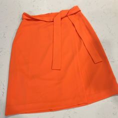 New With Tags Orange Workwear Skirt With Lining, Spring Workwear Belted Mini Skirt, Orange Lined Skirt For Workwear, Orange Lined Skirt For Work, Orange Skirt For Workwear In Summer, Chic Orange Knee-length Skirt, Chic Knee-length Orange Skirt, Orange Workwear Skirt For Spring, Spring Workwear Belted Skort