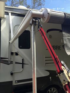 an rv is parked with its door open and the awnings extended to allow shade