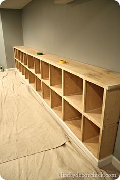 an empty room with some shelves on the floor