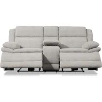 the reclining sofa has two seats and one arm rests on it's back