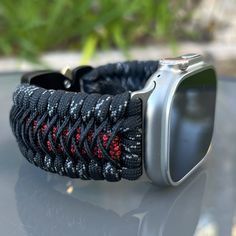 "Handcrafted with 100% Nylon Paracord \"MADE IN USA\".   Our Products include:    ➖Custom handcrafted watch bands \"According to You\". No matter how small or big your wrist size, we will craft your perfect fitting band (wrist size picture measurement required).  ➖Variety of styles to choose from. You may order your band \"As pictured\", or feel free to request changes. If you don't see your favorite style in our page or watch category yet, please contact us and we can discuss your options.  ➖Variety of buckles or clasps (Prices may vary).  ➖FREE FIRST CLASS USPS SHIPPING FOR DOMESTIC U.S. ORDERS (Includes U.S. Military APO/FPO Address Overseas).  Please, refer to policies for handcrafting time frames https://www.etsy.com/shop/Cording2U#policies. These may vary month to month depending on Wear-resistant Adjustable Apple Watch Band For Outdoor, Adjustable Wear-resistant Apple Watch Band For Outdoor, Adjustable Paracord Watch Bands For Outdoor, Modern Adjustable Wear-resistant Watch Bands, Adjustable Black Watch Bands With Custom Hardware, Adjustable Black Apple Watch Band For Outdoor, Custom Black Watch Bands For Outdoor, Adjustable Silver Watch Bands For Outdoor Use, Custom Black Outdoor Watch Bands