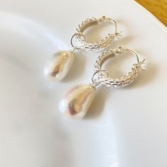 925 sterling silver Basket Weave Hoop earrings with a single Drop Pearl, each pearl is approx. 10mm x 15mm. The hoops are 10mm and the total drop is 30mm. choose either gold or silver from the drop down menu Pearls are the birthstone for June and have long been associated with purity, humility and innocence. So it may be said that the June birthstone meaning is "sweet simplicity."  Your item will arrive in an organza gift pouch, or choose a luxury gift box as illustrated from the drop down menu. Small Silver Hoop Earrings With Pearl Charm, Silver Small Hoop Earrings With Pearl Charm, Small Hoop Silver Earrings With Pearl Charm, Silver Huggie Hoop Earrings With Pearl Charm, Small Hoop Silver Pearl Earrings, Silver Teardrop Pearl Hoop Earrings, Silver Pearl Small Hoop Earrings, Silver Teardrop Hoop Earrings With Pearl Charm, Sterling Silver Hoop Pearl Earrings