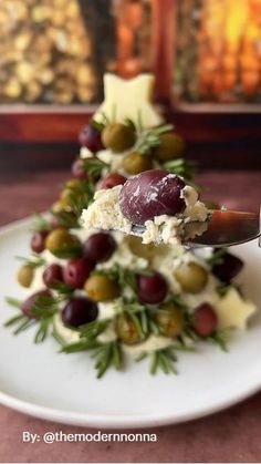 a white plate topped with olives and cheese