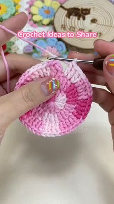 someone is crocheting together with yarn to make a small flower ornament