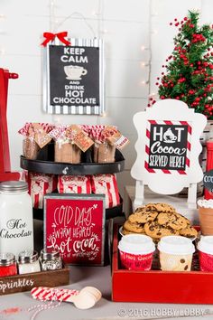 a christmas dessert table with cookies, hot chocolate and other holiday treats on it's tray