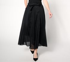 Sashay through the streets knowing all eyes will be on you in this feminine, flowy midi skirt. The chic bottom ties at the waist, accentuating your curves and creating a flattering silhouette. From BEAUTIFUL by Lawrence Zarian. Elegant Black Skirt With Tie Waist, Chic Spring Wrap Skirt With Gathered Detail, Elegant Voluminous Maxi Skirt For Day Out, Elegant Flowy Wrap Skirt For A Day Out, Elegant Spring Wrap Skirt For Daywear, Elegant Flowy Midi Wrap Skirt, Spring Night Out Gathered Maxi Skirt, Gathered Maxi Skirt For Night Out In Spring, Gathered Maxi Skirt For Spring Night Out