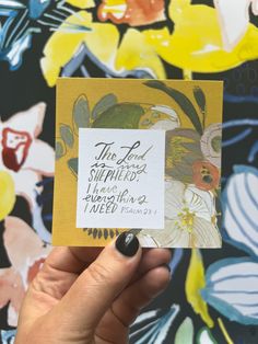 a hand holding up a card with the words, the lord is shepherd and flowers