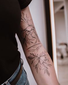 a woman with a flower tattoo on her arm