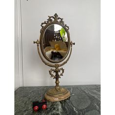 a mirror sitting on top of a table next to a toy train