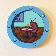 a cartoon character sitting at a table with food in front of him on the wall