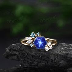 a ring with blue stones and diamonds on it