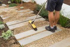 a man is using a mop to clean the ground