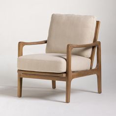 a wooden chair with a beige upholstered seat and back cushion on a white background