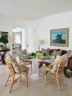 a living room filled with furniture and a painting on the wall