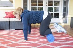 a woman is doing push ups on the floor