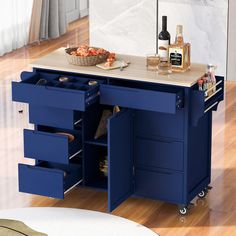 a blue kitchen island with drawers on wheels