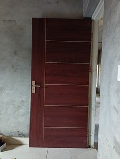 a wooden door is open in an empty room