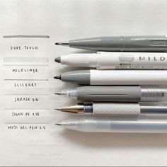 four different pens sitting on top of each other