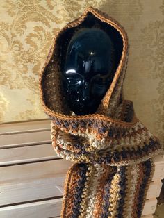 a crocheted scarf with a hood on it