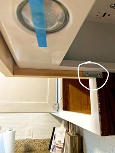 the blue tape is taped to the ceiling above the kitchen sink