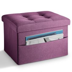 a purple ottoman with magazine holders in the bottom and an open file drawer underneath it